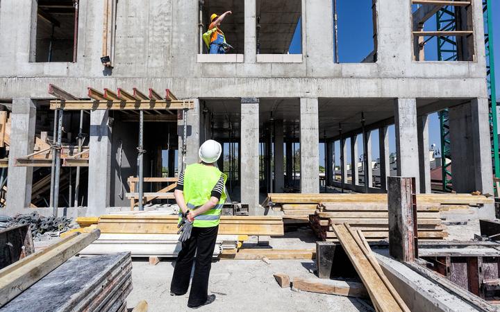 Construction site manager of a building site looking on a structure