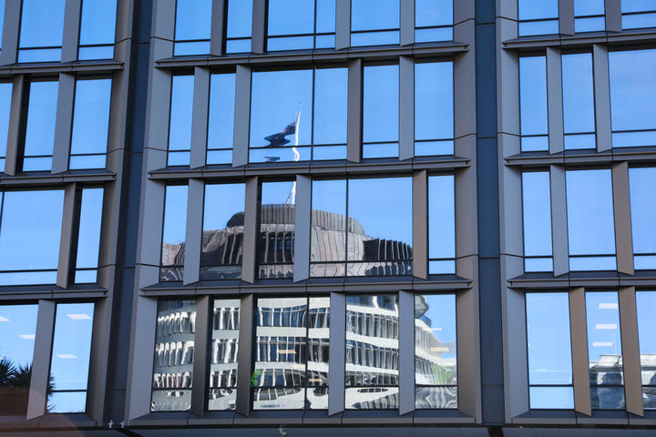 The Beehive reflected in a Ministry building