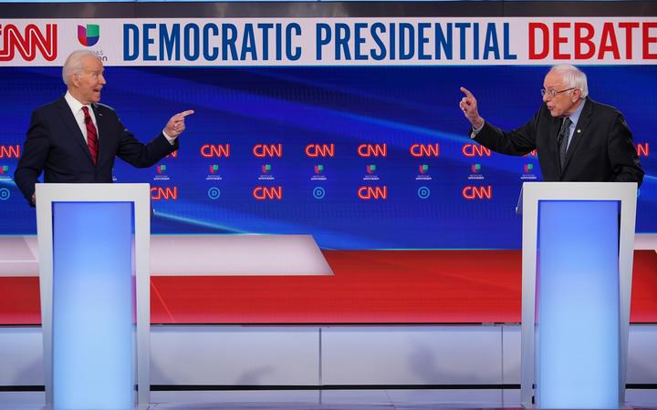 Democratic presidential hopefuls former US vice president Joe Biden (L) and Senator Bernie Sanders point fingers at each other as they take part in the 11th Democratic Party  presidential debate in Washington  on March 15, 2020. 