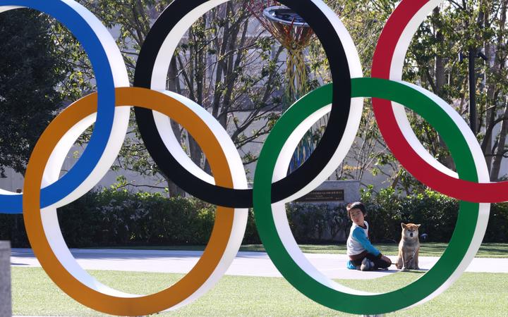 The Olympic Symbol is pictured at the New National Stadium, a venue for the opening ceremony of the 2020 Tokyo Olympics and Paralympics in Shinjuku Ward, Tokyo on March 24, 2020.