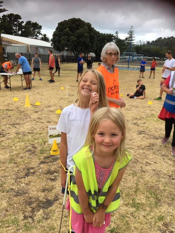 Shelagh Saprunoff (back) volunteering at Gisborne parkrun with grandchildren Zosia (front) and Ivy Costello.