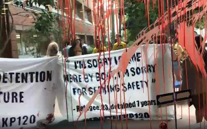 Protesters splashed red paint on windows and buildings at the University of Queensland, Australia