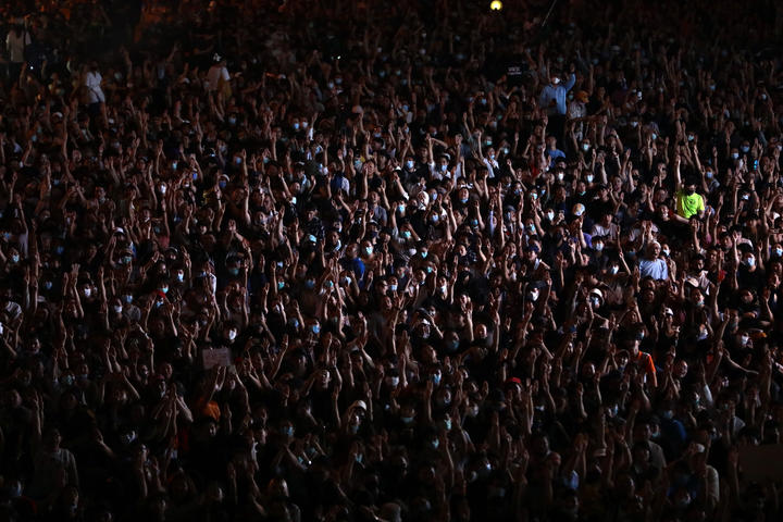 Pro-democracy protesters in Bangkok make the three-finger salute as they defy a ban on demonstrations, on 15 October 2020.