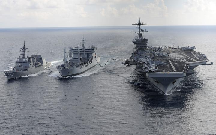 Aircraft carrier USS Theodore Roosevelt (CVN 71) and Japanese Maritime Self-defense Force Akizuki-class destroyer JS Fuyuzuki (DD-118)(L) transit alongside the Indian Deepak-class fleet tanker INS Shakti (A 57)(C) during a replenishment-at-sea exercise as a part of Exercise Malabar 2015. 