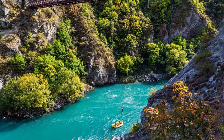 Journey to the South Island of New Zealand. A picturesque river in a mountain gorge. Attraction Bungee jumping on a bridge over a mountain river. 