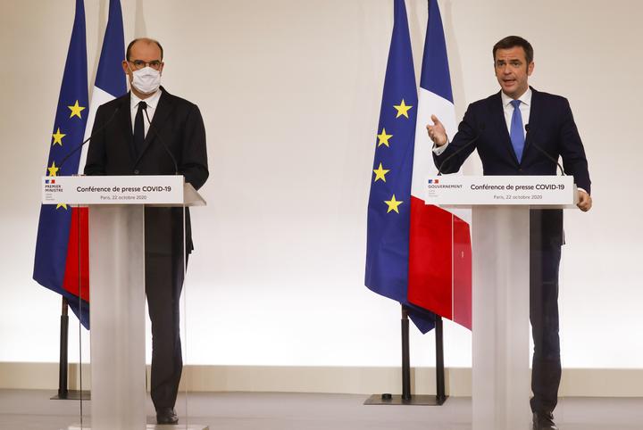 French Health Minister Olivier Veran (right) and French Prime Minister Jean Castex at a media conference in Paris, announcing the changeover of several departments to "maximum alert" and new curfew measures in order to curb the spread of the Covid-19.