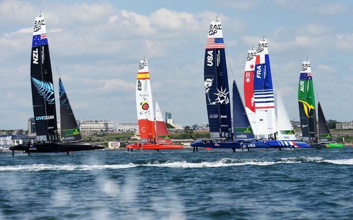 New Zealand SailGP Team, Spain SailGP Team, USA SailGP Team, Japan SailGP Team, France SailGP Team and Australia SailGP Team foiling across Plymouth Sound on race day 1 at Great Britain SailGP, Event 3, Season 2 in Plymouth, UK. 17 July 2021. 