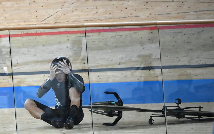 New Zealand's Aaron Gate reacts after crashing during the men's track cycling team pursuit finals during the Tokyo 2020 Olympic Games at Izu Velodrome in Izu, Japan, on August 4, 2021. 