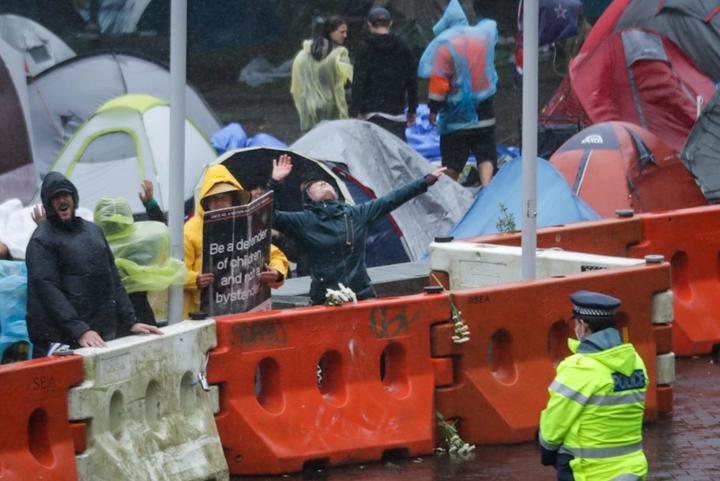 Protesters in the rain outside Parliament on 13 February, 2022.