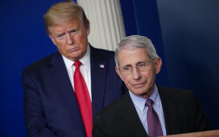 Director of the National Institute of Allergy and Infectious Diseases Anthony Fauci, flanked by US President Donald Trump, speaks during the daily briefing on the novel coronavirus, which causes COVID-19, in the Brady Briefing Room of the White House on April 22, 2020, in Washington, DC. 