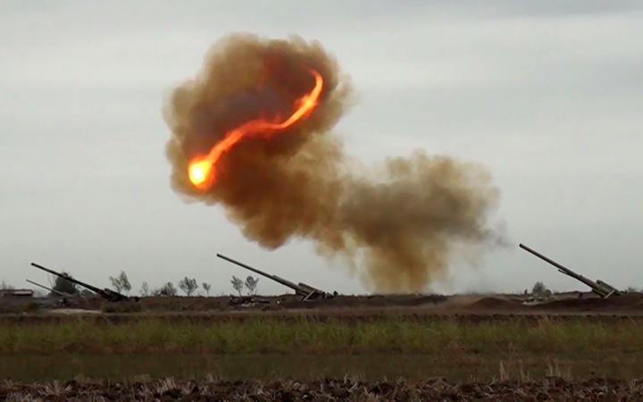 An image grab taken from a video made available by the Azerbaijani Defence Ministry on September 28, 2020, allegedly shows an Azeri artillery strike towards the positions of Armenian separatists in the breakaway region of Nagorno-Karabakh.