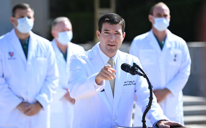 White House physician Sean Conley answers questions surrounded by other doctors, during an update on the condition of US President Donald Trump, on October 4, 2020, at Walter Reed Medical Center in Bethesda, Maryland. 