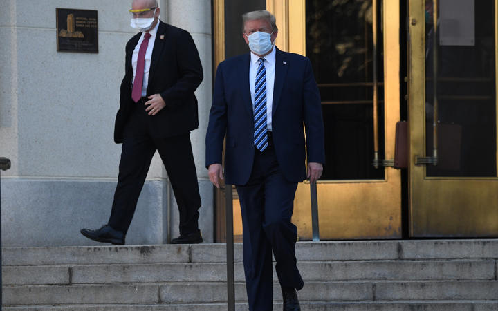 US President Donald Trump walks out of Walter Reed Medical Center in Bethesda, Maryland, to return to the White House.