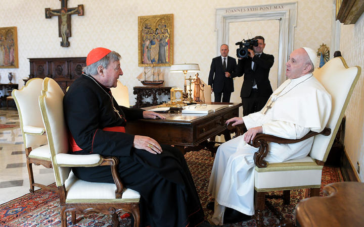 Pope Francis talks with Cardinal George Pell