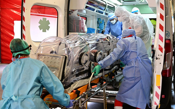 Medical staff transfer from the Garbagnate Milanaise hospital a patient with Covid-19 in a bio-containment stretcher for infectious diseases to Varese hospital.