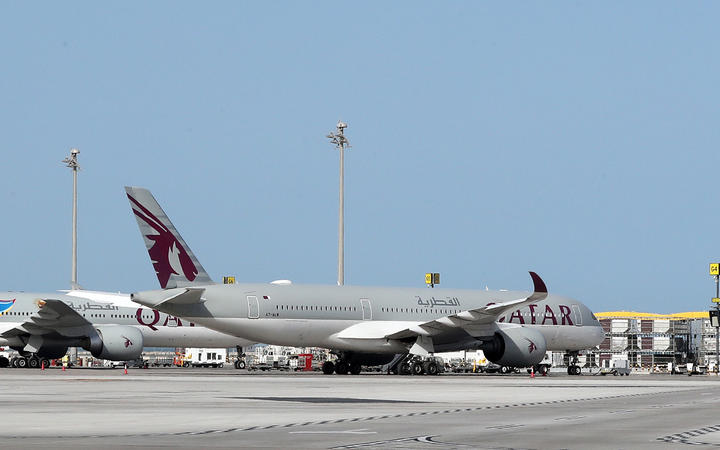 A Qatar Airways Airbus A350-941 aircraft is seen on the tarmac at Hamad International Airport in the Qatari capital Doha. 