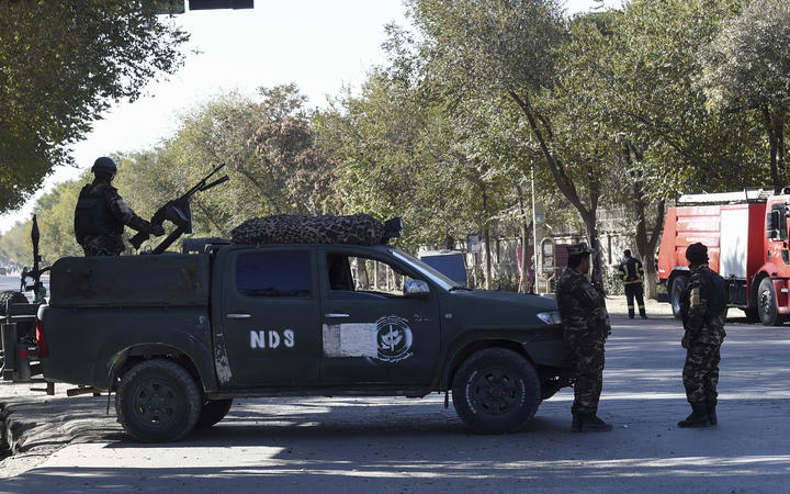 Security personnel stand guard outside Kabul University on November 2, 2020 after gunmen stormed the university.