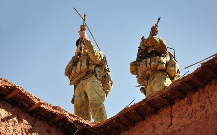 A handout photo released by Australian Department of Defence on October 21, 2009 shows Australian soldiers from the Special Operations Task Group using their rifle scopes to investigate the surrounding mountains during an operation in southern Afghanistan. 