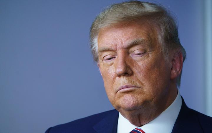 US President Donald Trump looks down during an event on lowering prescription drug prices in the Brady Briefing Room of the White House in Washington, DC on November 20, 2020.