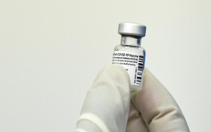 A nurse holds a vial of the Pfizer-BioNTech vaccine against Covid-19.