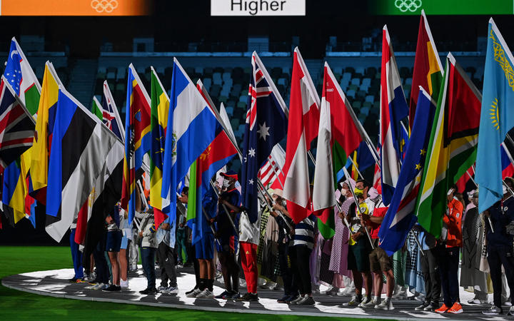 Athletes carrying nations' flags attend the closing ceremony of the Tokyo 2020 Olympic Games, at the Olympic Stadium, in Tokyo.