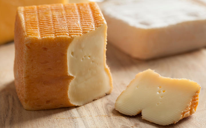 Piece of Belgian Limburger cheese on a cheese board.