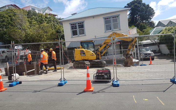 Workers at the site of the main break in Helen Street in the Wellington suburb of Brooklyn.