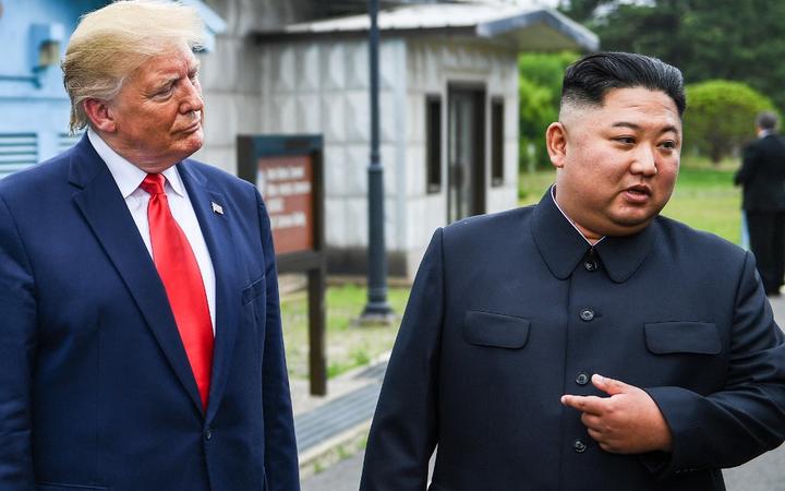 North Korea's leader Kim Jong Un speaks as he stands with US President Donald Trump south of the Military Demarcation Line that divides North and South Korea, in the Joint Security Area (JSA) of Panmunjom in the Demilitarized zone (DMZ) on June 30, 2019. 