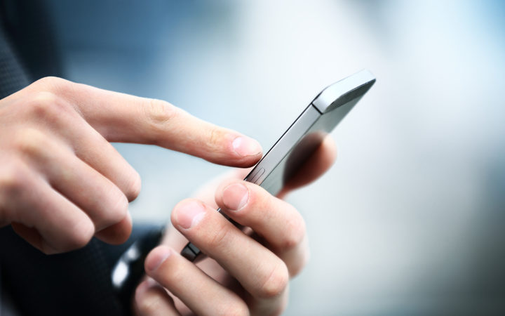 Close up of a man using mobile smart phone