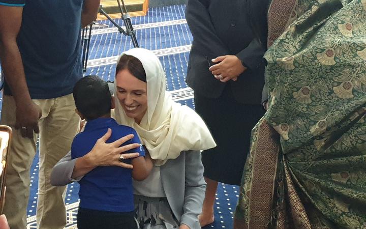 Ardern hugs the great grandson of Ashraf Ali Razak, who died in the mosque attack. 