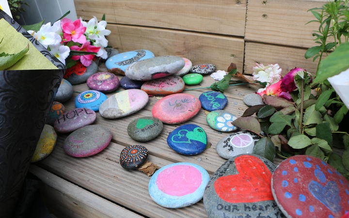 People have left rocks with messages of support and drawings at the Linwood Mosque entrance on the one-year anniversary since the shootings.