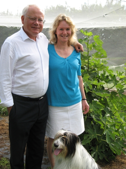 Murray Douglas, Helen Walker and dog with their fig trees in Hawkes Bay.