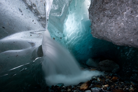 Summer melt water pours into a glacial cave with the force of an open fire hydrant. Viedma Glacier, Patagonia.