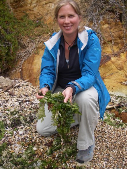 Candida Savage holding the green seaweed sea lettuce